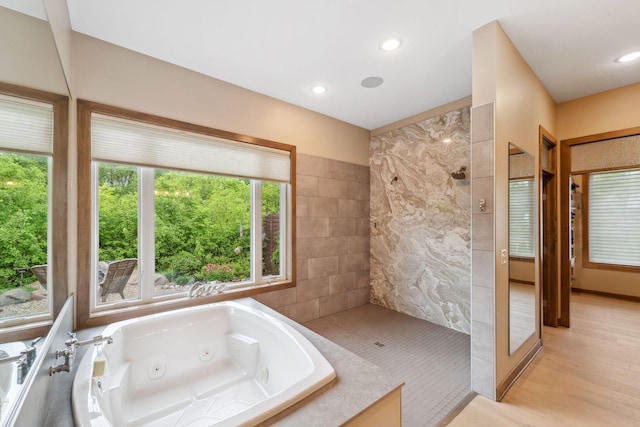 18565 Revere Ave, Spring Lake Twp, MN 55372 - bathroom with a walk in shower, plenty of natural light, a jetted tub, and recessed lighting