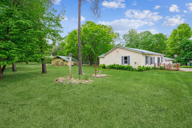 2628 River Rd, Sterling Twp, WI 54024 - view of green lawn featuring a deck and view of wooded area