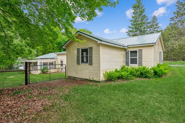 2628 River Rd, Sterling Twp, WI 54024 - view of side of home featuring metal roof and a gate
