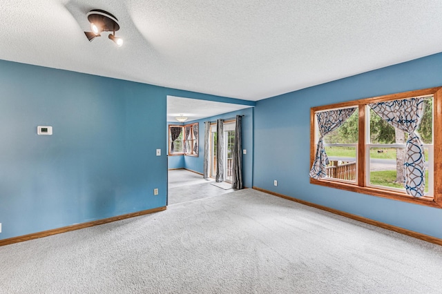 2628 River Rd, Sterling Twp, WI 54024 - carpeted empty room featuring baseboards, healthy amount of natural light, and a textured ceiling