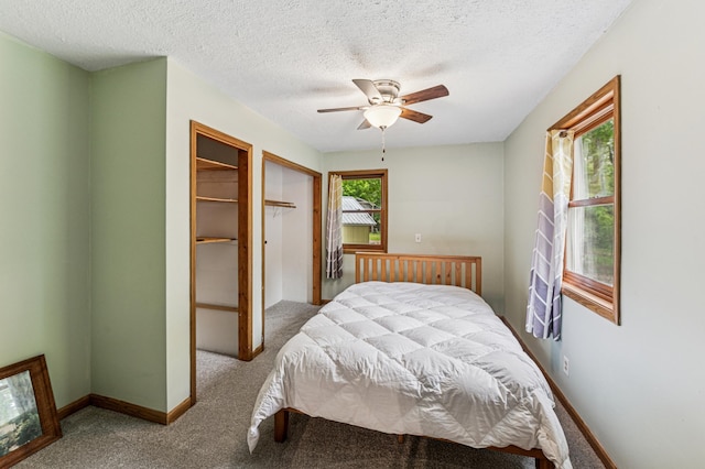 2628 River Rd, Sterling Twp, WI 54024 - carpeted bedroom with a textured ceiling, baseboards, and a ceiling fan