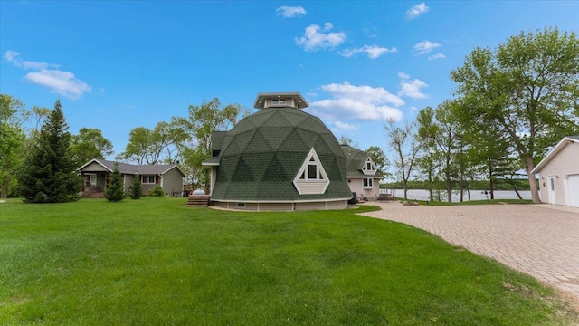 9630 Walleye Rd NW, Brandon, MN 56315 - rear view of property featuring a lawn, a garage, a water view, a shingled roof, and driveway