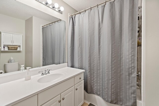 13848 52nd Ave N, Plymouth, MN 55446 - full bathroom featuring a textured ceiling, vanity, shower / tub combo, and toilet