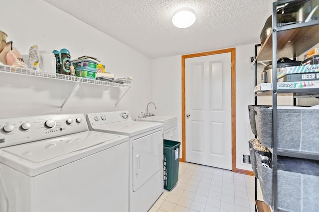 13848 52nd Ave N, Plymouth, MN 55446 - laundry room featuring washing machine and clothes dryer, a textured ceiling, and light tile patterned floors