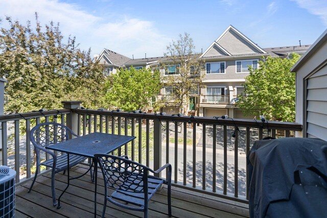 13848 52nd Ave N, Plymouth, MN 55446 - wooden deck featuring a grill, outdoor dining area, central AC unit, and a residential view