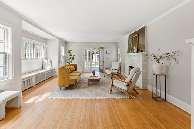 2901 Vincent Ave N, Minneapolis, MN 55411 - living area with radiator, healthy amount of natural light, light wood-style flooring, a brick fireplace, and ornamental molding