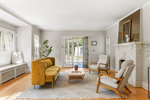 2901 Vincent Ave N, Minneapolis, MN 55411 - living area featuring radiator, light wood-style floors, a fireplace, ornamental molding, and baseboards