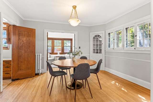 2901 Vincent Ave N, Minneapolis, MN 55411 - dining area with radiator heating unit, light wood finished floors, crown molding, and baseboards