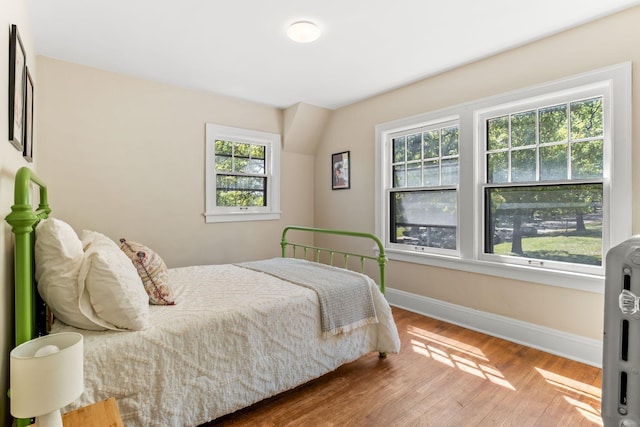 2901 Vincent Ave N, Minneapolis, MN 55411 - bedroom with multiple windows, baseboards, and wood finished floors