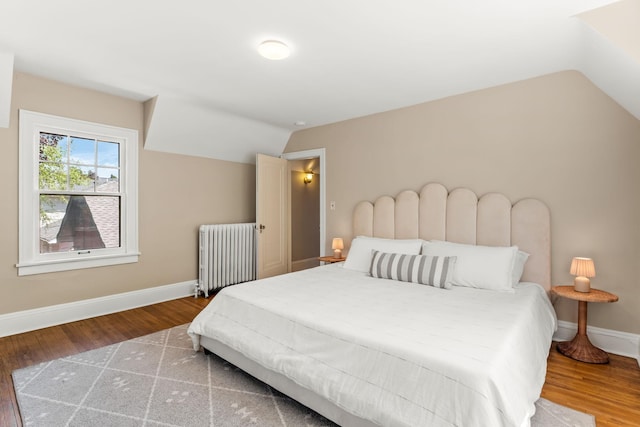2901 Vincent Ave N, Minneapolis, MN 55411 - bedroom featuring radiator, vaulted ceiling, baseboards, and wood finished floors