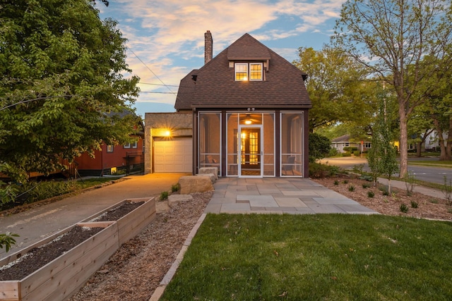 2901 Vincent Ave N, Minneapolis, MN 55411 - rear view of house featuring a chimney, a garden, concrete driveway, a lawn, and a shingled roof