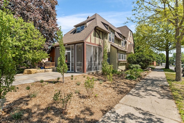2901 Vincent Ave N, Minneapolis, MN 55411 - back of house featuring a sunroom and a shingled roof