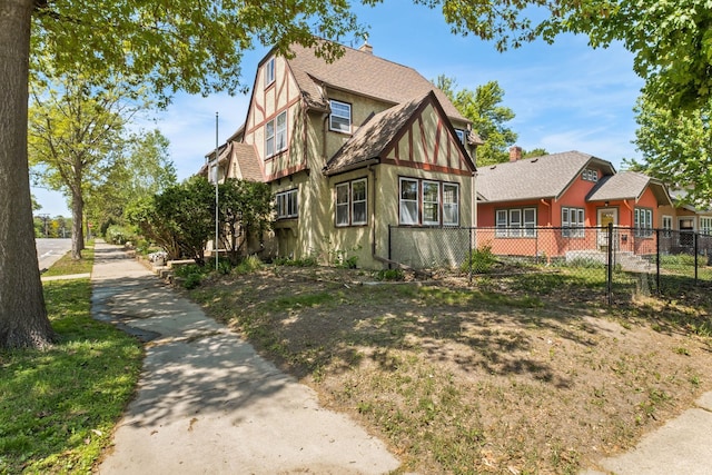 2901 Vincent Ave N, Minneapolis, MN 55411 - view of front of home with fence, a shingled roof, and a chimney