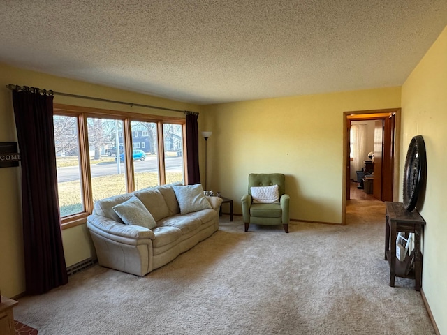carpeted living area with healthy amount of natural light and a textured ceiling