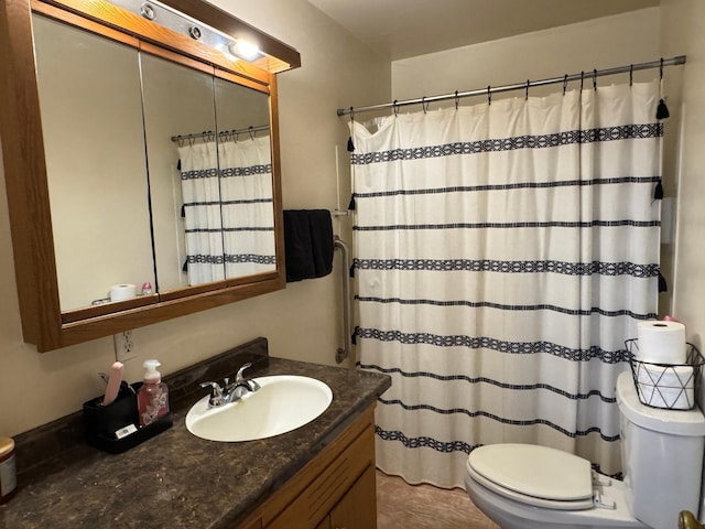 full bath featuring toilet, vanity, and curtained shower