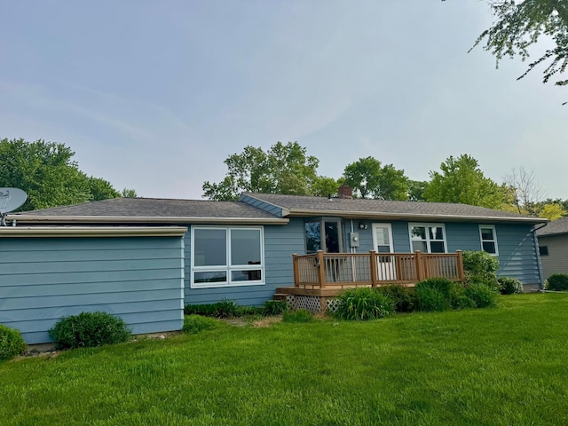 1001 Birch Ave, Olivia, MN 56277 - back of house featuring a deck, a lawn, and a chimney