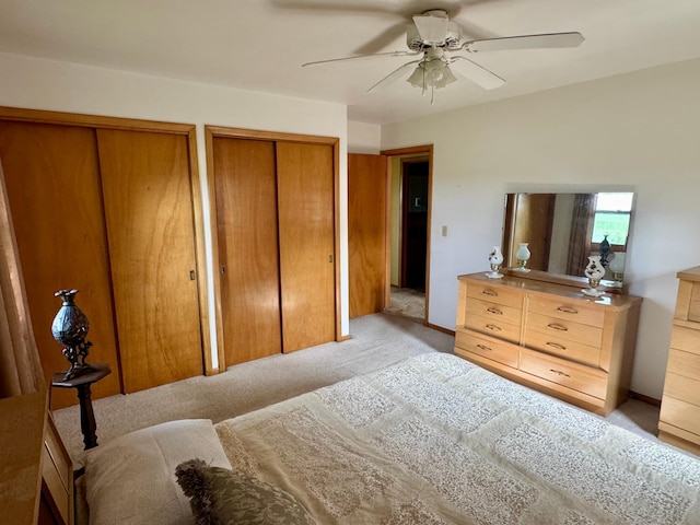 1001 Birch Ave, Olivia, MN 56277 - bedroom with light carpet, two closets, and ceiling fan