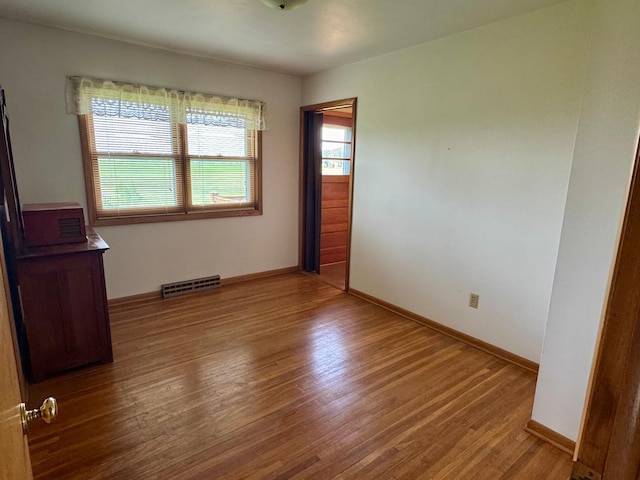1001 Birch Ave, Olivia, MN 56277 - spare room featuring wood finished floors and baseboards