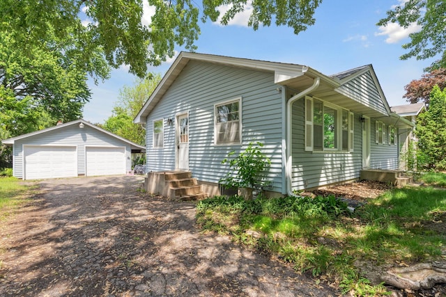2237 Holloway Ave E, North Saint Paul, MN 55109 - view of side of property featuring an outbuilding, a garage, and entry steps