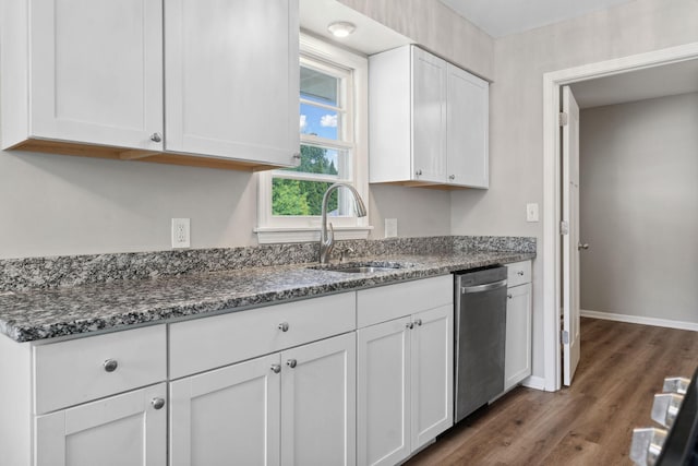 2237 Holloway Ave E, North Saint Paul, MN 55109 - kitchen featuring a sink, dishwasher, white cabinetry, dark stone counters, and dark wood-style flooring