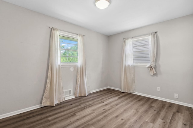 2237 Holloway Ave E, North Saint Paul, MN 55109 - spare room with wood finished floors and baseboards