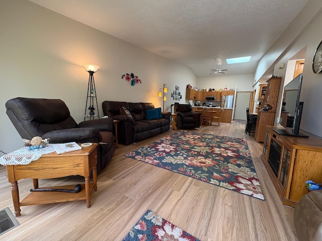40 Broadway, Plainview, MN 55964 - living area with light wood-style flooring, ceiling fan, and a skylight
