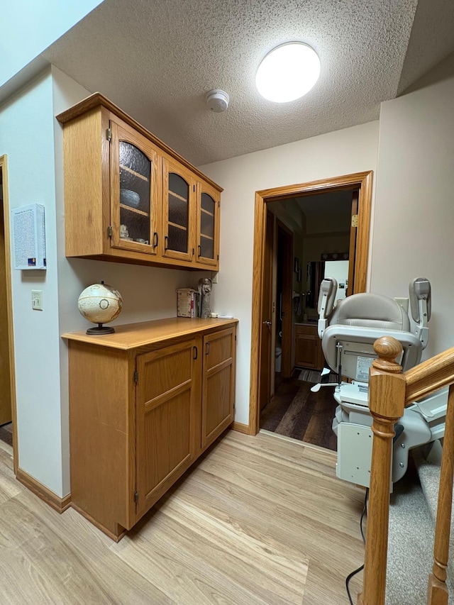 40 Broadway, Plainview, MN 55964 - corridor with light wood-style floors, a textured ceiling, and baseboards