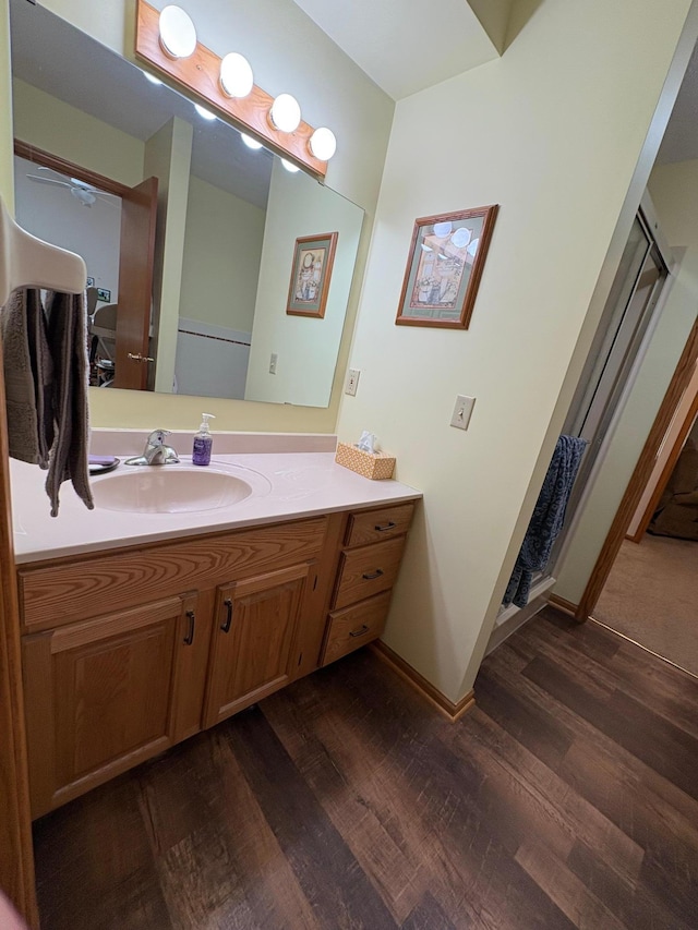 40 Broadway, Plainview, MN 55964 - bathroom featuring wood finished floors, vanity, a stall shower, and baseboards