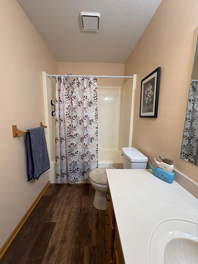 40 Broadway, Plainview, MN 55964 - bathroom featuring shower / bath combo, wood finished floors, toilet, vanity, and a textured ceiling