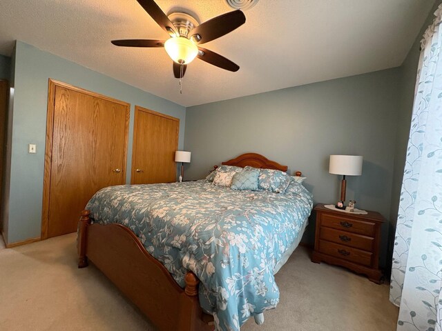 40 Broadway, Plainview, MN 55964 - bedroom featuring light colored carpet, two closets, and ceiling fan