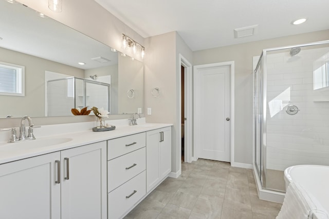 5107 Allen Dr, Woodbury, MN 55129 - full bath with a shower stall, double vanity, recessed lighting, and baseboards