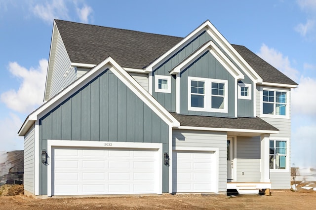 5107 Allen Dr, Woodbury, MN 55129 - view of front of house featuring board and batten siding, a shingled roof, and driveway
