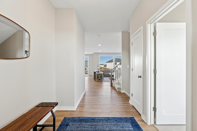 5107 Allen Dr, Woodbury, MN 55129 - hallway with light wood-style flooring, stairs, and baseboards