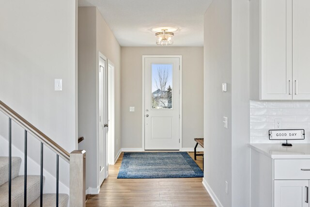 5107 Allen Dr, Woodbury, MN 55129 - entryway featuring light wood-style floors and baseboards