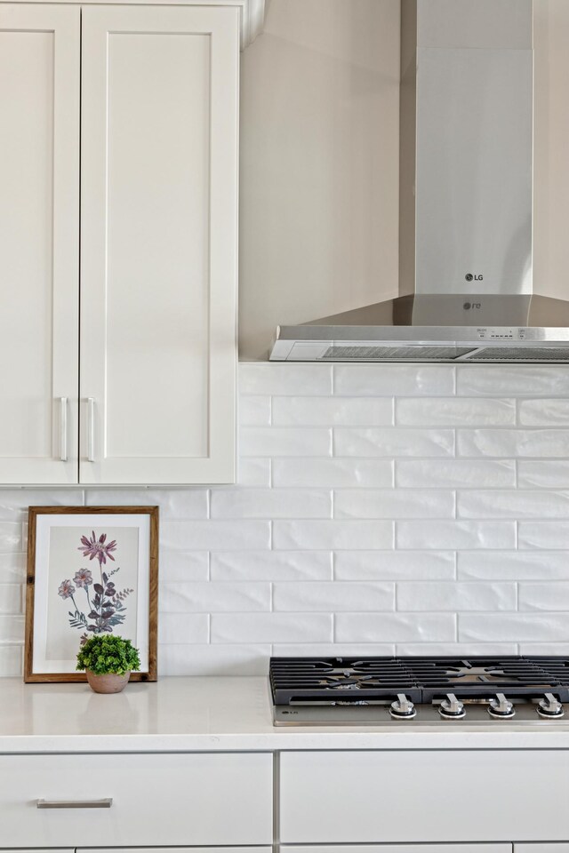 5107 Allen Dr, Woodbury, MN 55129 - kitchen view of wall chimney exhaust hood, white cabinetry, backsplash, and light countertops