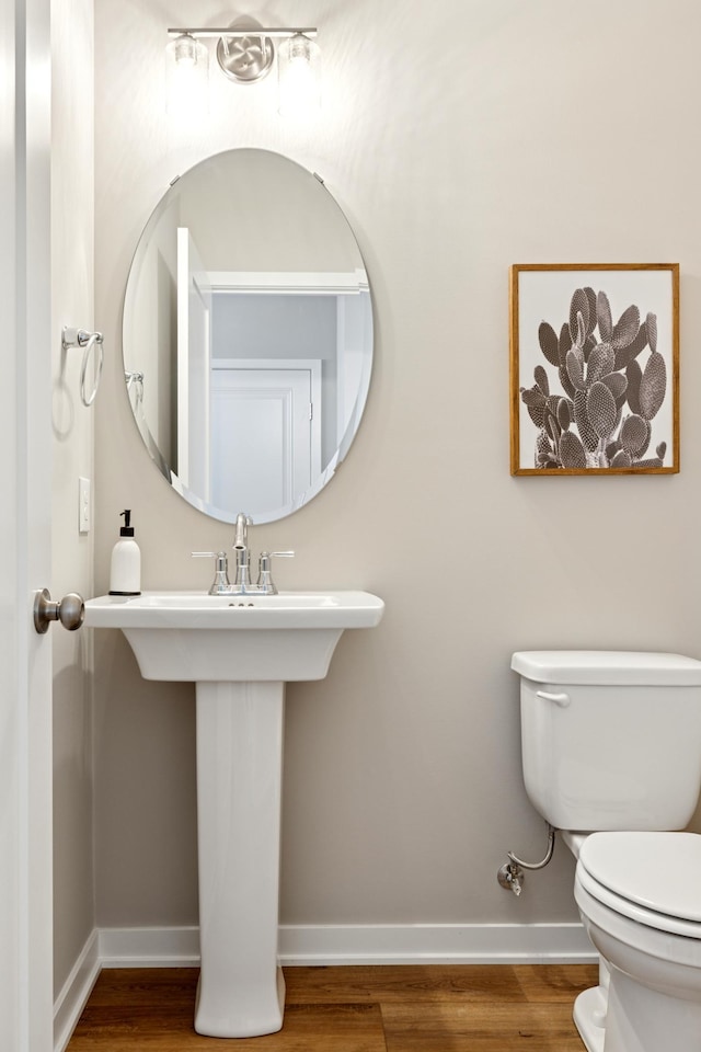 5107 Allen Dr, Woodbury, MN 55129 - bathroom with baseboards, wood finished floors, and toilet