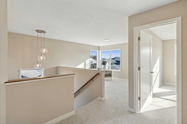 5107 Allen Dr, Woodbury, MN 55129 - hallway featuring an upstairs landing, carpet, and baseboards
