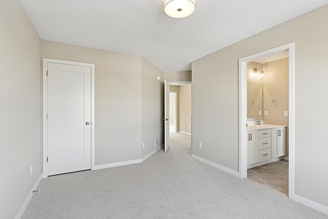 5107 Allen Dr, Woodbury, MN 55129 - unfurnished bedroom with light carpet, baseboards, ensuite bath, and a sink