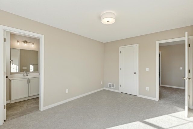 5107 Allen Dr, Woodbury, MN 55129 - unfurnished bedroom with light colored carpet, baseboards, ensuite bathroom, and a sink