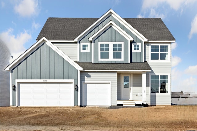 5107 Allen Dr, Woodbury, MN 55129 - view of front of house featuring driveway, board and batten siding, and roof with shingles