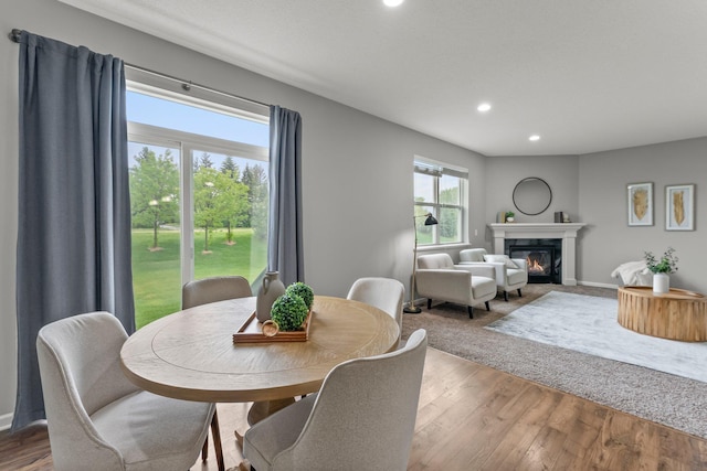 6317 153rd St, Savage, MN 55378 - dining space featuring recessed lighting, a glass covered fireplace, wood finished floors, and baseboards