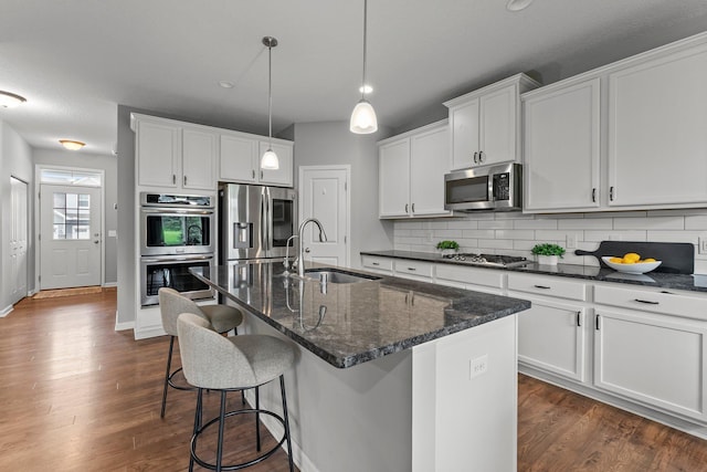 6317 153rd St, Savage, MN 55378 - kitchen with appliances with stainless steel finishes, a sink, backsplash, a center island with sink, and recessed lighting