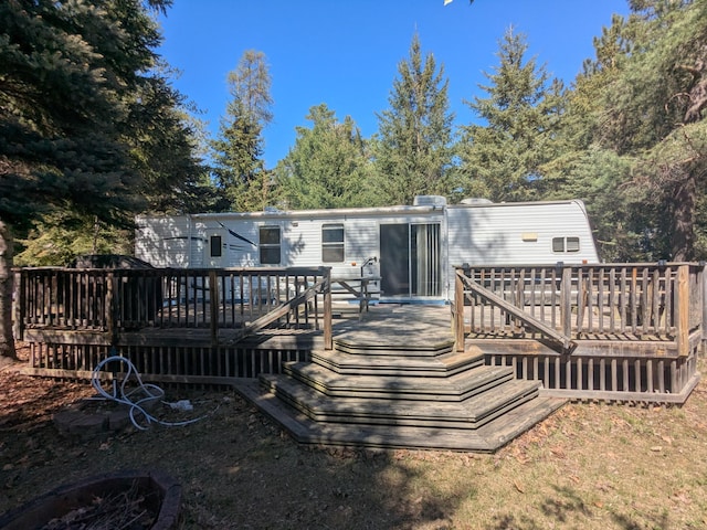 rear view of property featuring a wooden deck
