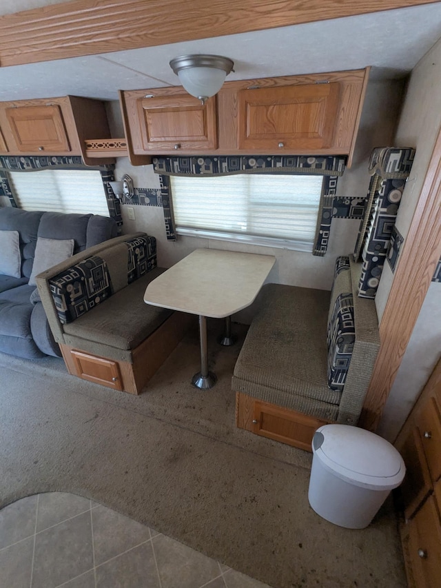 kitchen with tile patterned flooring and carpet floors