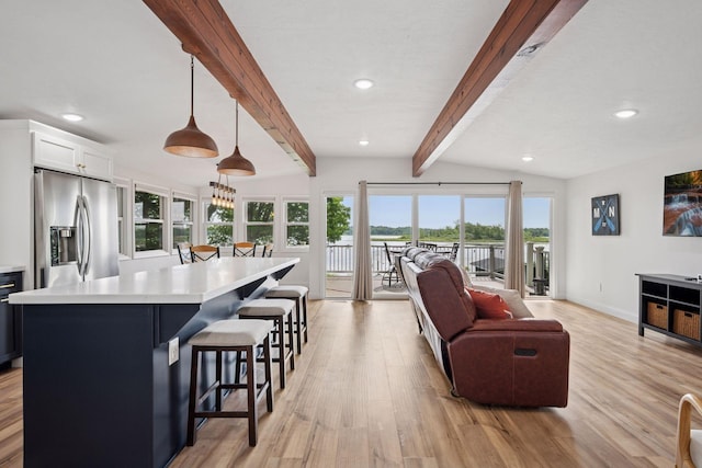 30558 376th Ave, Nordland Twp, MN 56431 - kitchen featuring stainless steel fridge, light wood-style floors, open floor plan, light countertops, and a kitchen breakfast bar