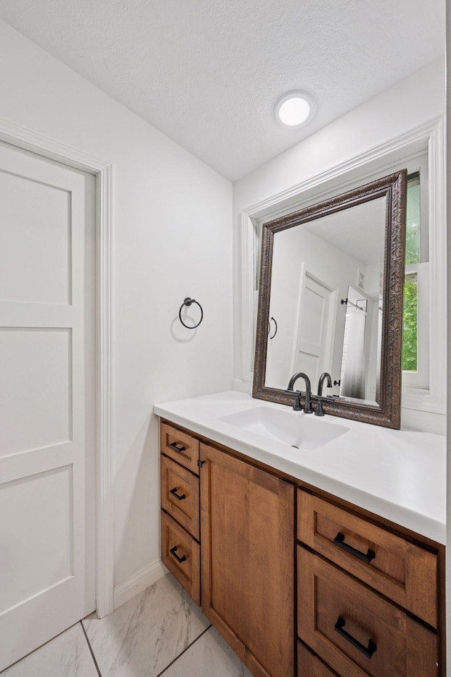 30558 376th Ave, Nordland Twp, MN 56431 - bathroom featuring vanity, marble look tiles, and a textured ceiling