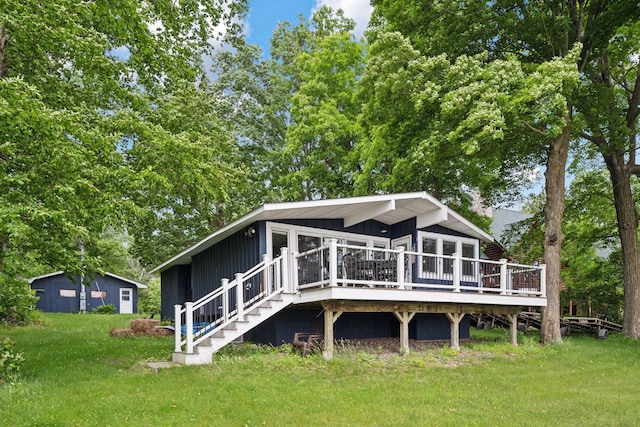 30558 376th Ave, Nordland Twp, MN 56431 - rear view of house featuring a deck, a lawn, and stairs
