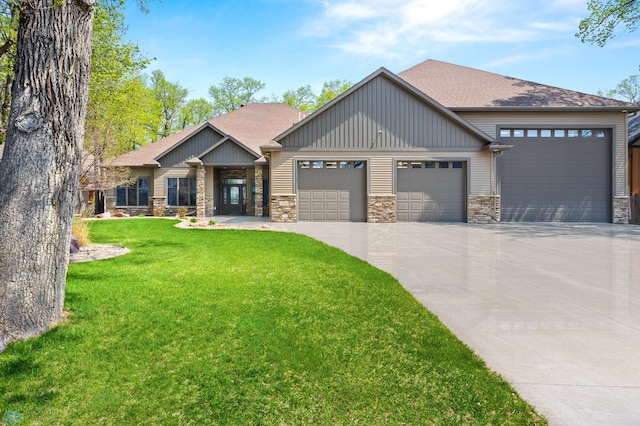 106 Beaton Dr, West Fargo, ND 58078 - craftsman-style home with stone siding, driveway, a garage, a front yard, and roof with shingles