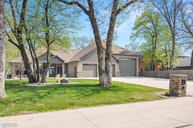 106 Beaton Dr, West Fargo, ND 58078 - view of front of property with stone siding, an attached garage, concrete driveway, board and batten siding, and a shingled roof