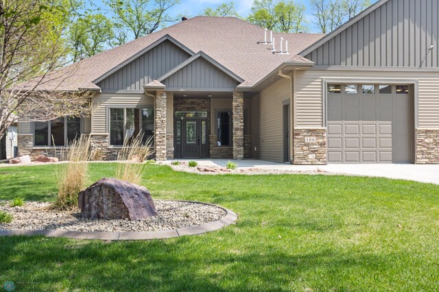106 Beaton Dr, West Fargo, ND 58078 - craftsman-style house featuring stone siding, roof with shingles, a garage, a front yard, and board and batten siding